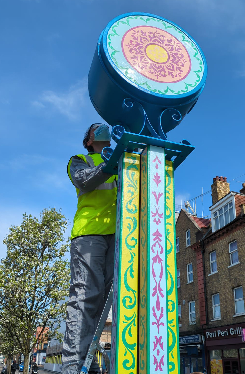 Painting a clock in Harlsden 