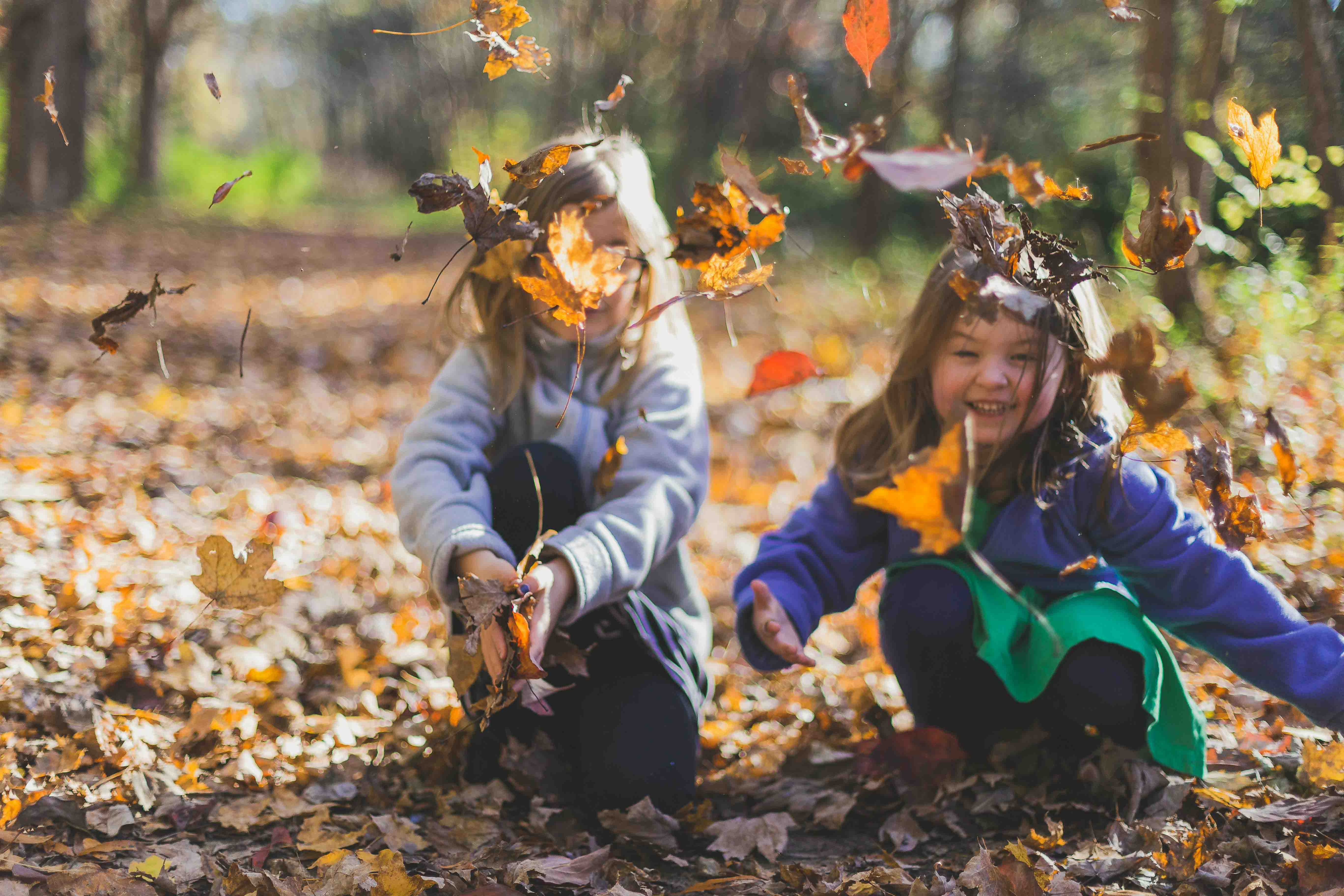 Kids playing with leaves in nature Kids playing with leaves in nature